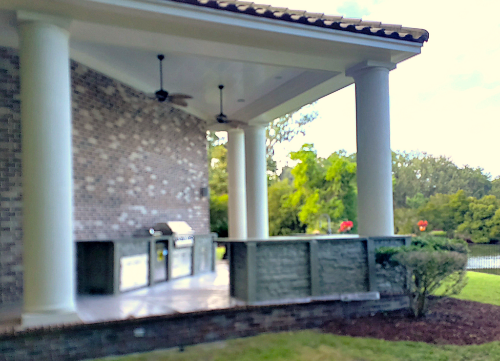 Custom luxury outdoor kitchen in Myrtle Beach area with Marvelcrete® precast cabinetry, stainless steel grill, and designer finishes, showcased in Debordieu Colony, SC.