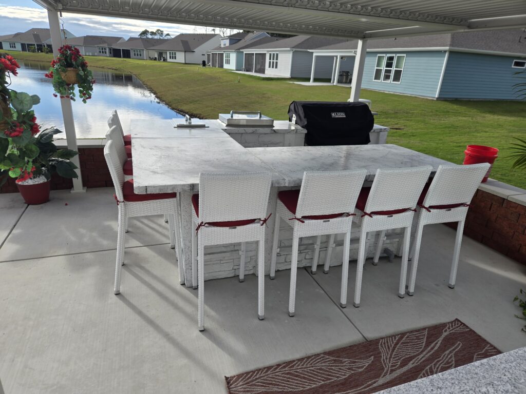 StoneKitchen™ custom outdoor kitchen featuring patent-pending Marvelcrete™ precast cabinets, polished concrete countertops, and commercial-grade grill station in North Myrtle Beach backyard