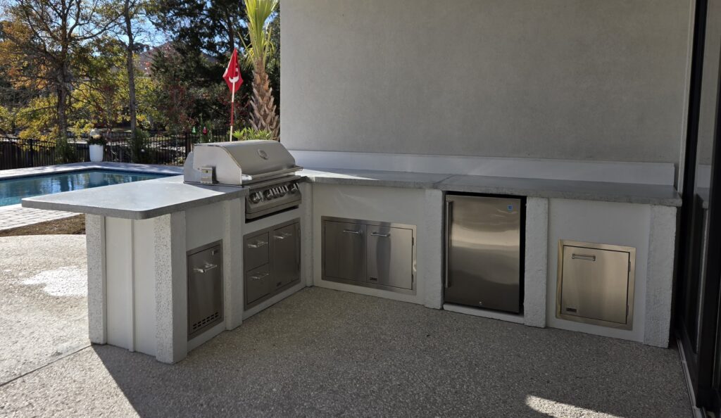 Luxury custom outdoor kitchen in Myrtle Beach featuring Marvelcrete® cabinetry and 16-gauge 304 stainless steel appliances