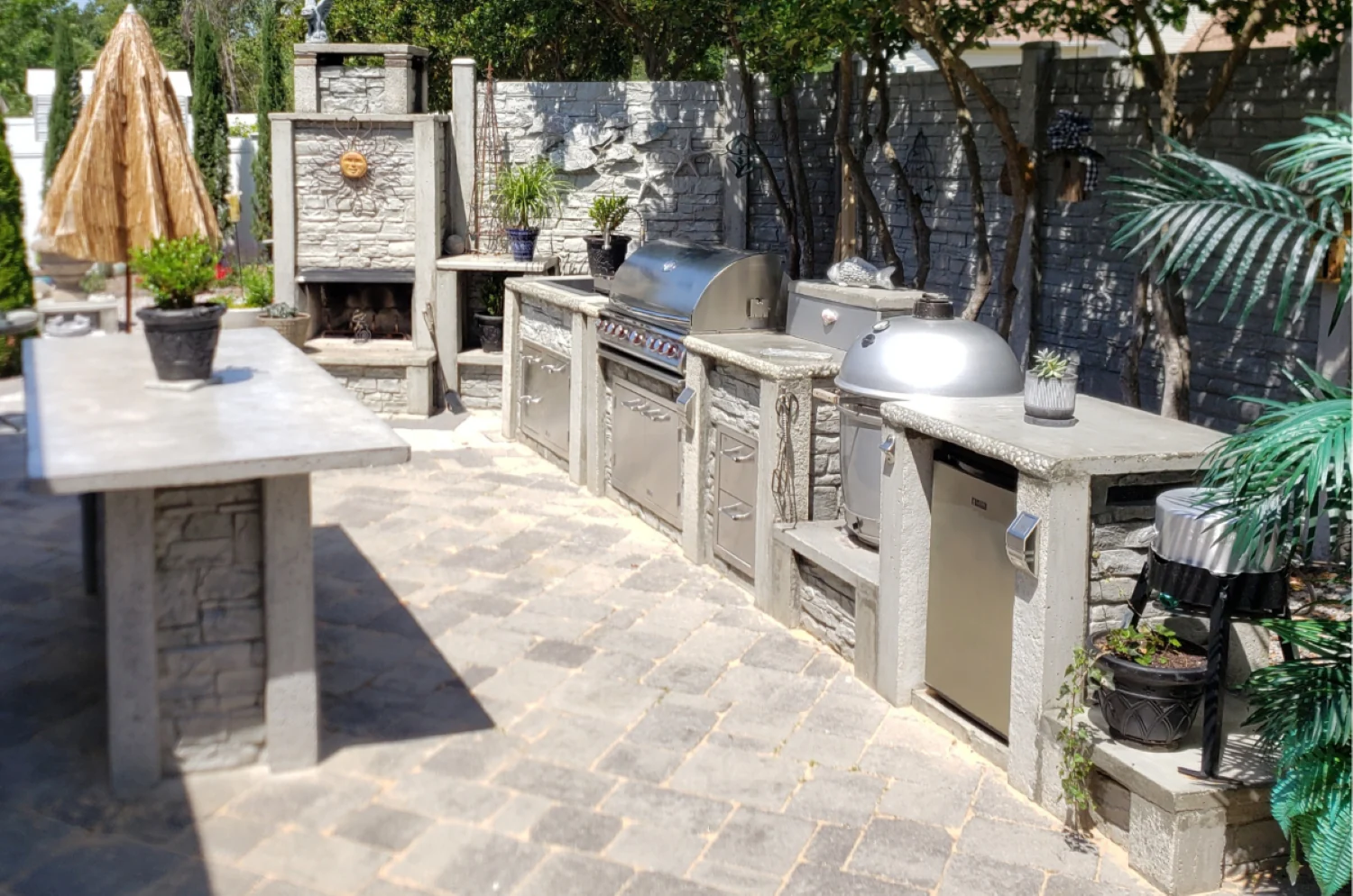 StoneKitchen® outdoor kitchen and bar with grill, Kamado cooker, refrigeration and fireplace