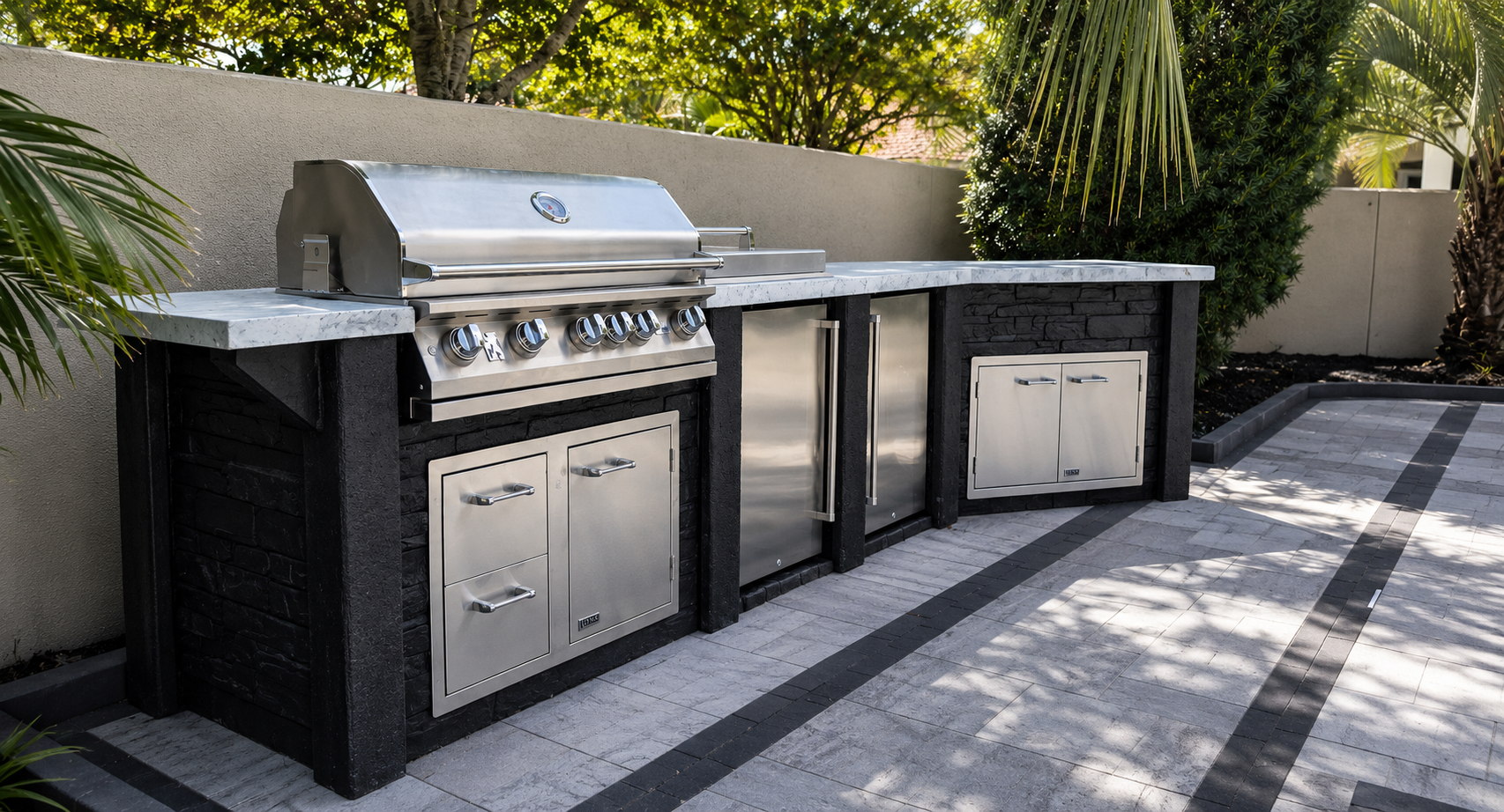 StoneKitchen® custom outdoor kitchen with built-in grill, refrigeration, storage, and concrete countertops in Coastal Carolina