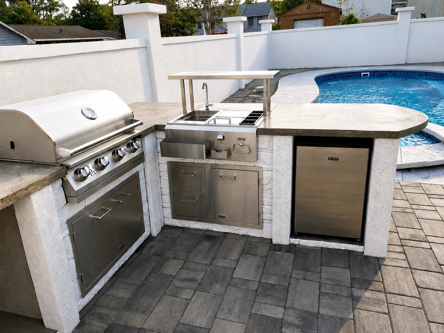 Custom outdoor kitchen beside a pool